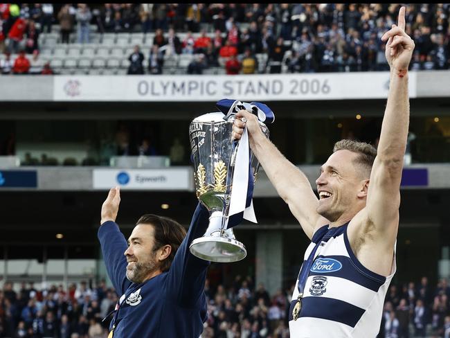 MELBOURNE, AUSTRALIA - SEPTEMBER 24: Chris Scott, Senior Coach of the Cats and Joel Selwood of the Cats hold up the Premiership Cup after the 2022 AFL Grand Final match between the Geelong Cats and the Sydney Swans at the Melbourne Cricket Ground on September 24, 2022 in Melbourne, Australia. (Photo by Darrian Traynor/AFL Photos/via Getty Images)