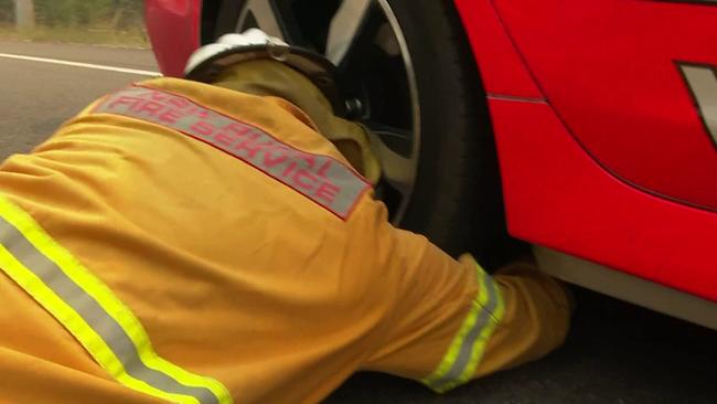 The volunteer firefighter retrieved the mother possum first. Picture: TNV