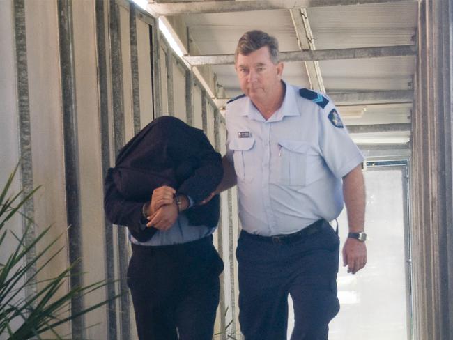 Giardina is led away from the Hervey Bay court .