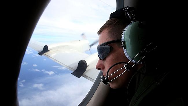 RAAF Airbourne Electronics Analyst Bodine Luscott keeps watch for debris on-board a AP-3C Orion during a search mission in the Southern Indian Ocean on March 26, 2014 in Perth, Australia. Picture: AFP