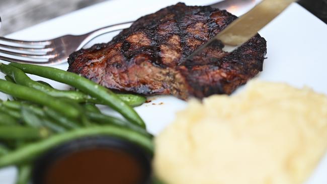 Katter orders a 300 gram rump steak – well-done – with sides of garlic marsh and green beans at the Old Canberra Inn. Picture: Martin Olllman