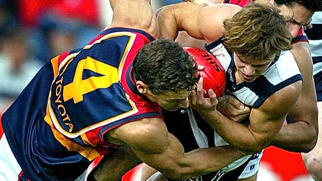 Geelong’s David Spriggs tackled by Matthew Clarke and James Begley.