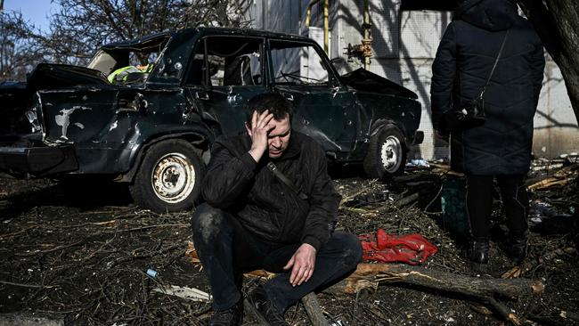 A man sits outside his destroyed building after bombings on the eastern Ukraine town of Chuguiv. Picture: Aris Messinis / AFP