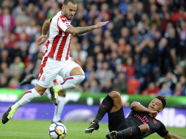 Stoke's Jese, left, and Arsenal's Alex Oxlade-Chamberlain battle for the ball during the English Premier League soccer match between Stoke City and Arsenal at the Bet365 Stadium in Stoke on Trent, England, Saturday, Aug. 19, 2017. (AP Photo/Rui Vieira)