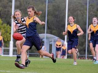 FINALS TIME: Fairholme's Evie Mason (left) punts the ball downfield with teammate Zoe Crooke in support. Fairholme will face Mountain Creek State High School in the semi-final of the AFLQ Schools Cup next week. Picture: Fairholme College