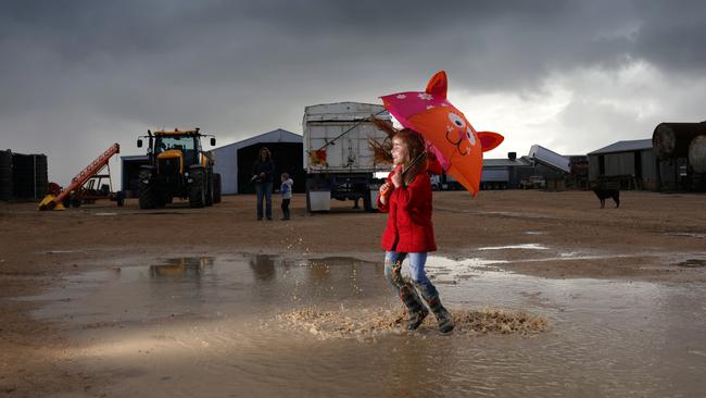 Shaylee Britza, 5, celebrates the downpour at the Hancock farm in Warrachie. Picture: Robert Lang.