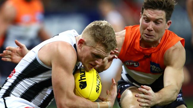 Adam Treloar is tackled by Toby Greene in Round 18. Picture: Getty Images