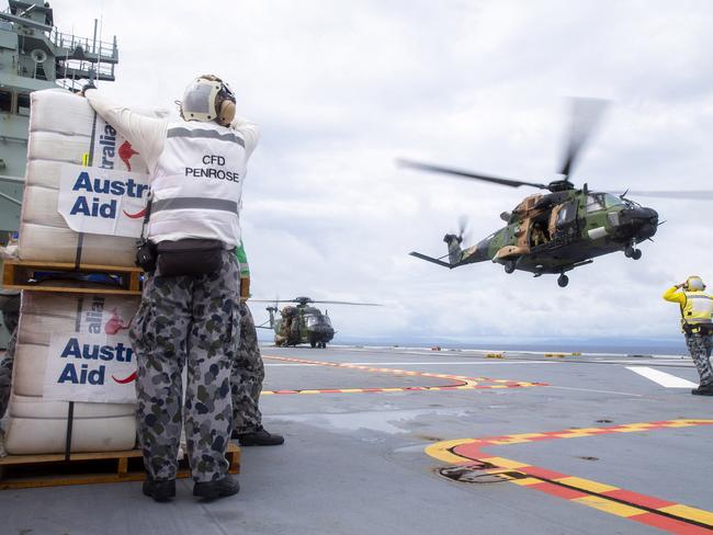 An Australian Army MRH-90 Taipan launches from the flight deck of HMAS Adelaide to drop disaster relief supplies to Nabouwalu on the island of Vanua Levu, Fiji, during Operation Fiji Assist. *** Local Caption *** Australian Defence Force (ADF) personnel delivered 14 tonnes of disaster relief supplies to Nabouwalu on the northern island of Vanua Levu, Fiji.  On Thursday 24 December 2020, over 600 ADF personnel deployed to Fiji on HMAS Adelaide to support the Fijian Governmentâs disaster relief efforts in the wake of Tropical Cyclone Yasa.  ADF elements are working with the Australian Department of Foreign Affairs and Trade to support the Republic of Fiji Military Forces (RFMF) who are assisting thousands of Fijians, including many from remote islands whose homes, schools and other local infrastructure were damaged or destroyed by the category 5 cyclone.