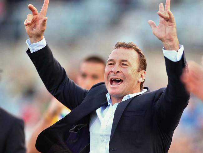 Raiders coach Ricky Stuart celebrates a try by his team on the sideline.