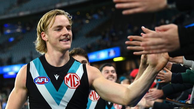 MELBOURNE, AUSTRALIA - JUNE 09: Miles Bergman of the Power high fives fans after winning  the round 13 AFL match between Western Bulldogs and Port Adelaide Power at Marvel Stadium, on June 09, 2023, in Melbourne, Australia. (Photo by Quinn Rooney/Getty Images)