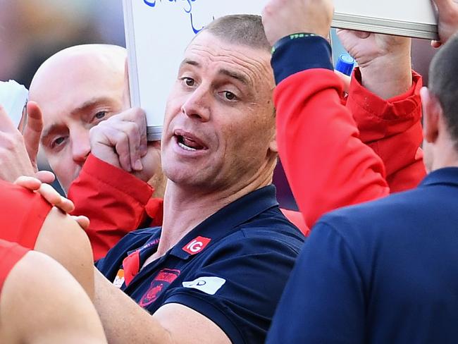 MELBOURNE, AUSTRALIA - JULY 01:  Demons head coach Simon Goodwin speaks to his players during the round 15 AFL match between the Melbourne Demons and the St Kilda Saints at Melbourne Cricket Ground on July 1, 2018 in Melbourne, Australia.  (Photo by Quinn Rooney/Getty Images)