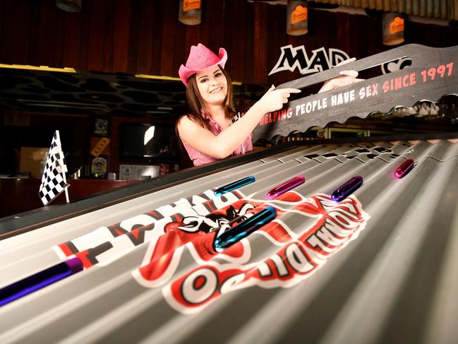 Mad Cow bartender Kristian Bowkett 21, gets a dildo race started. Picture: Alix Sweeney