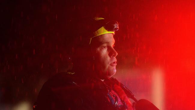 South Townsville Fire station manager Luke Smith assists at a unit complex in Alexandra Street, North Ward hit by flash flooding during monsoonal rain in Townsville. PICTURE: MATT TAYLOR.