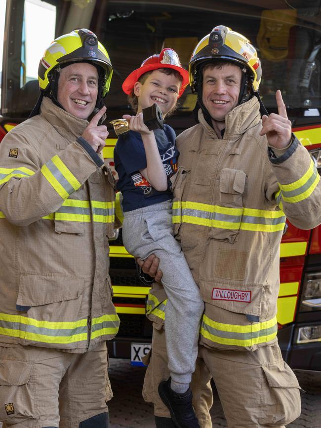 Best Book Week Costume winner, Texas Flynn with fire fighters Brett Maher and Mark Willoughby at Adelaide Station Picture: Kelly Barnes