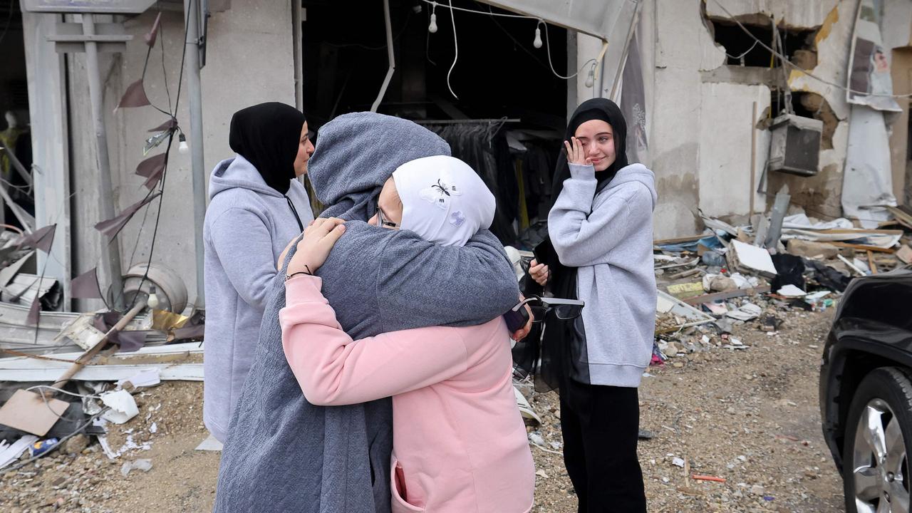 Women greet each other as displaced people make their way back to their homes in the south of Lebanon after the ceasefire took effect. Picture: Anwar AMRO/AFP