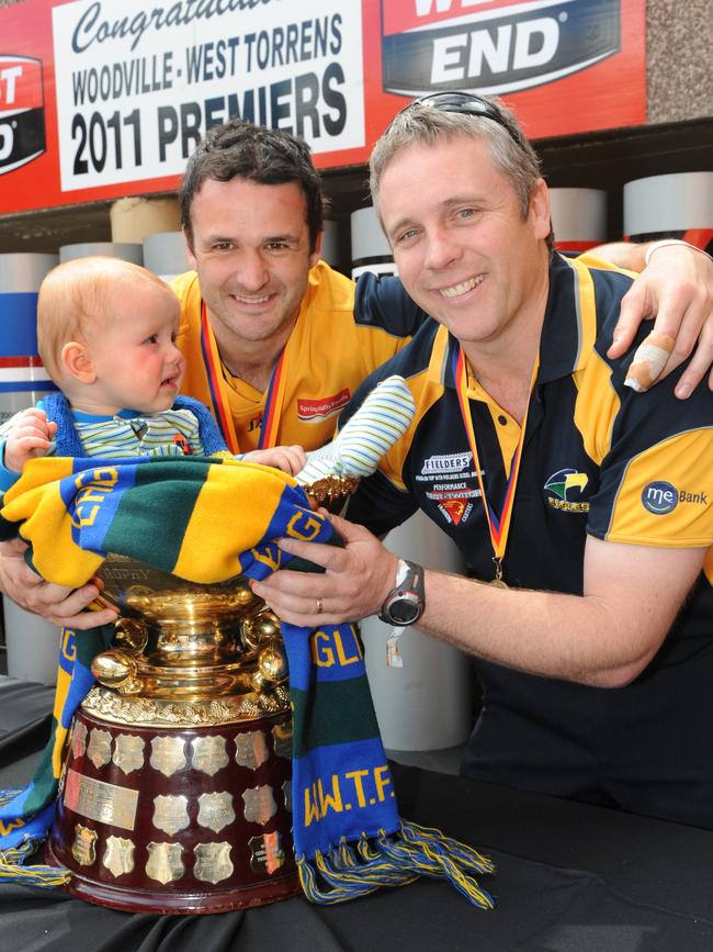 Woodville-West Torrens 2011 captain Mark McKenzie with Michael Godden after the Eagles’ triumph over Central District.