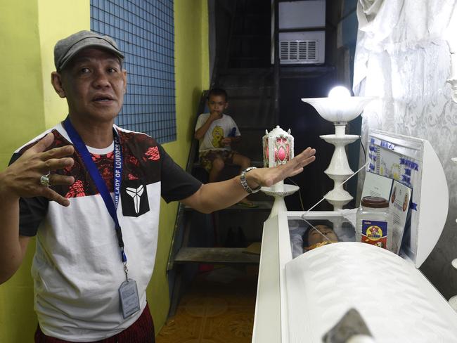 Saldy Delos Santos, the father of Kian Loyd speaks to journalists next to the coffin of his son, allegedly killed by a police anti-drug raid last August. Photo: Ted Aljibe/AFP