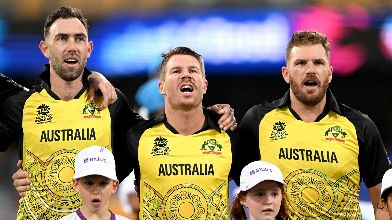 Glenn Maxwell, David Warner and Aaron Finch of Australia sing the national anthem before the T20 World Cup match against Ireland at The Gabba.