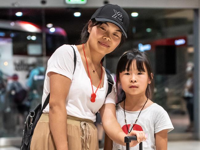 Melissa Zhu and daughter Emma photographed arriving at Sydney airport after being held in quarantine in Darwin. Picture: Monique Harmer