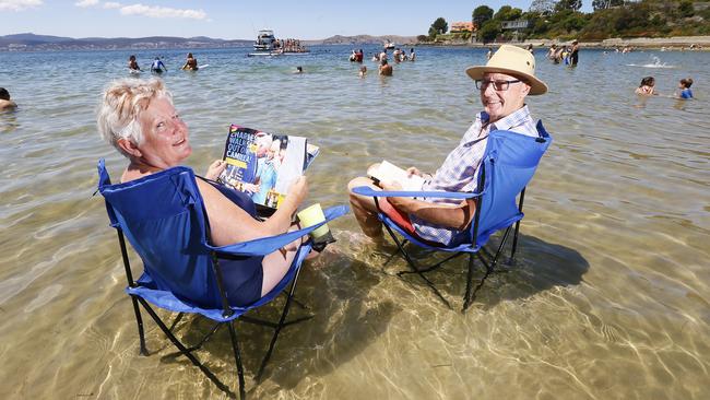 Vivi and Terry McDonnell, of Lenah Valley, soak up the sun at Sandy Bay. Picture: MATT THOMPSON