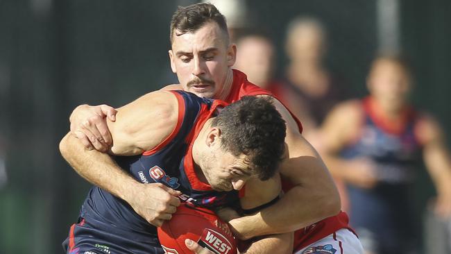 North Adelaide’s Alex Spina grabs Norwood's William Abbott in a terrific tackle. Picture: Dean Martin