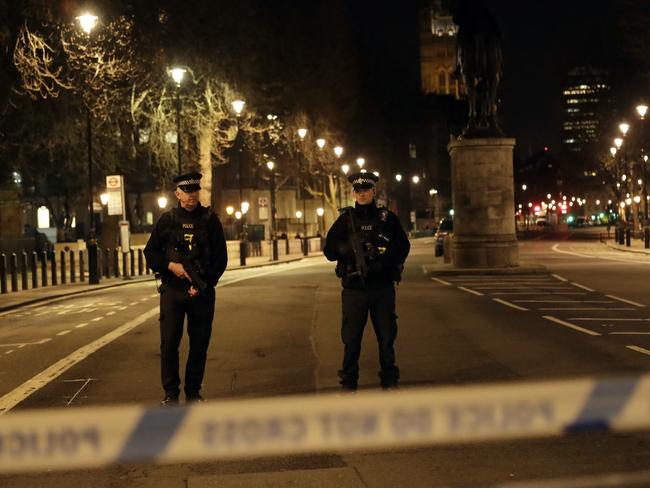 Two policemen stand guard at a cordoned-off area on the way to the Houses of Parliament in central London. Picture: AP