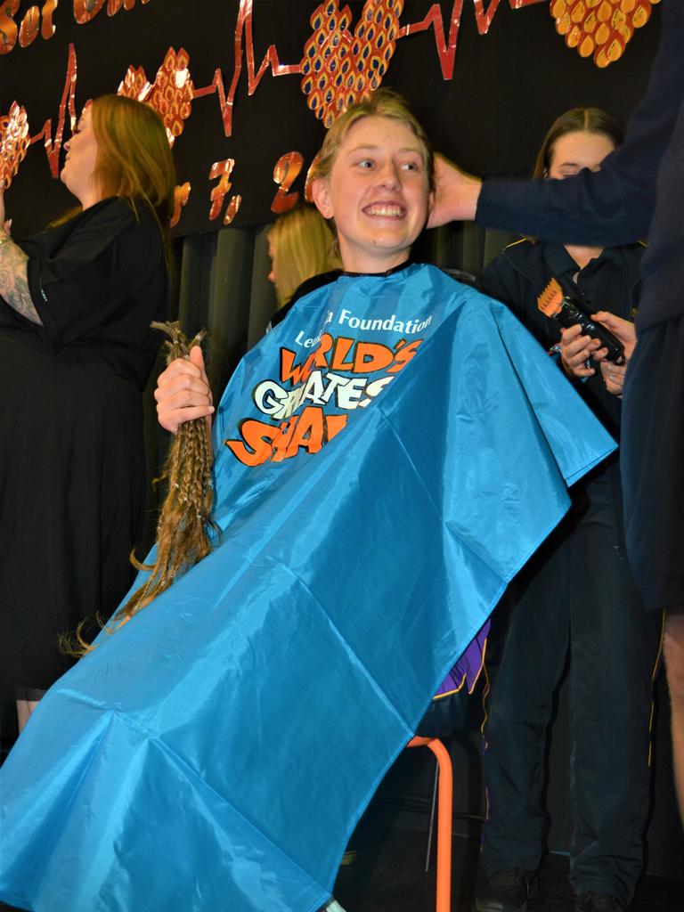 At the St Joseph's College 2023 World's Greatest Shave event is student Emily Chandler getting her hair cut by her support crew and hairdresser Natalie Schmidt from the Hair Room on Russell. Picture: Rhylea Millar