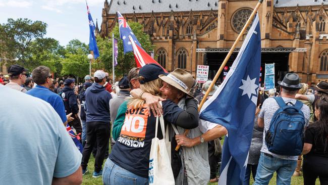 A woman holding a Eureka flag, a symbol of defiance. Picture: NCA NewsWire / David Swift