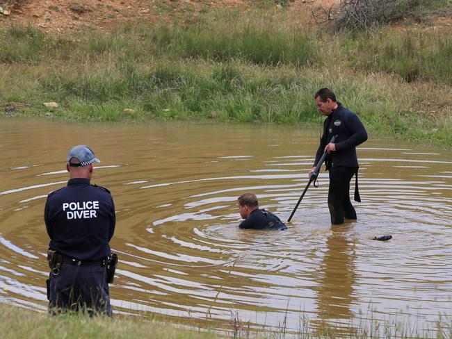 Police search a waterhole at the farm. Picture: NSW Police