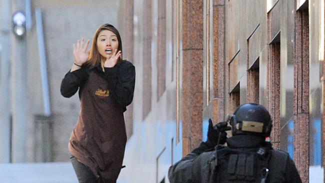 Sydney Siege hostage Elly Chen runs from the Lindt Chocolat cafe in Martin Place. Picture: AAP