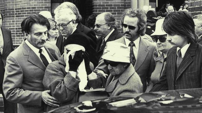 Clare ‘The Colonel’ Regan (face covered) at the funeral of her murdered gangster son, John Stewart Regan, in 1974. Picture: Victor Colin Sumner/Fairfax Media