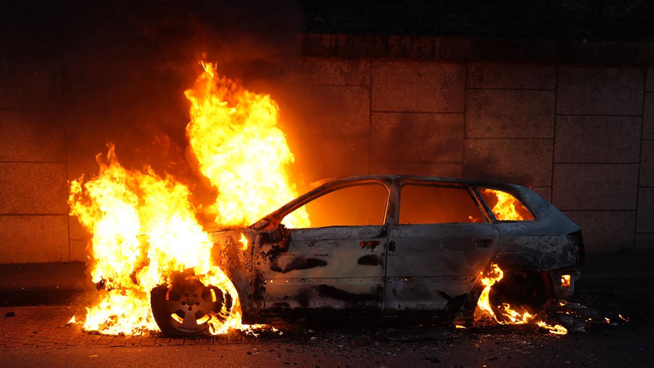 A burning car on the sidelines of a demonstration in Nanterre, west of Paris. Picture: AFP