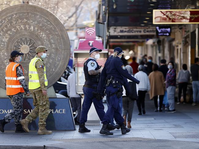 SUNDAY TELEGRAPH - Pictured are Police and Defence Force personnel patrolling the streets of Bankstown today as they are cracking down on people not following the rules. Picture: Tim Hunter.