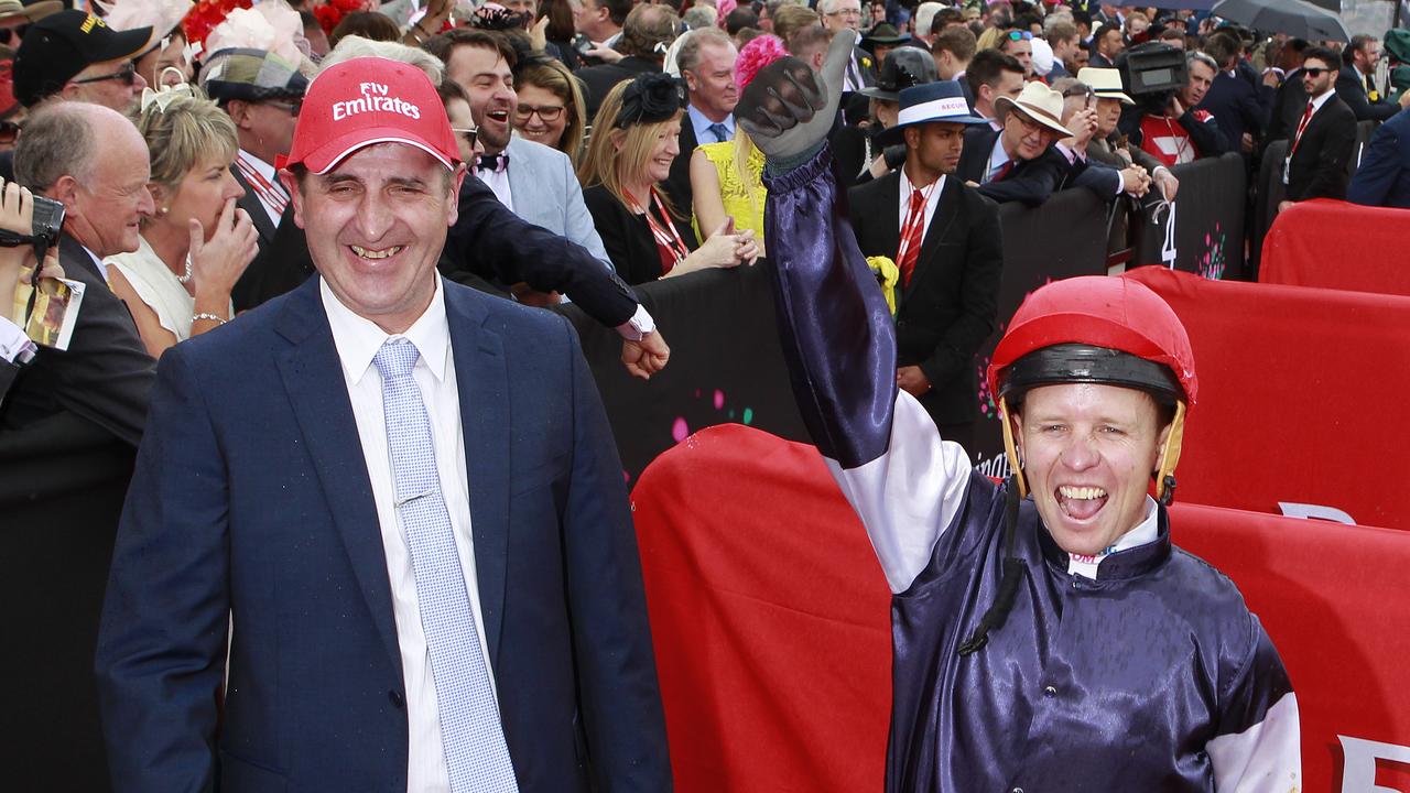 Jockey Kerrin McEvoy (right), with trainer Robert Hickmott, celebrate after Almandin won the 2016 Melbourne Cup. Picture: AAP Image/David Crosling