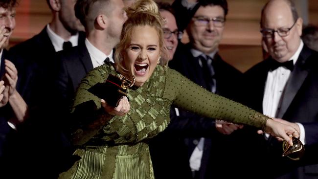 Adele accepts the award for album of the year at the 59th annual Grammy Awards. Picture: Matt Sayles/Invision/AP