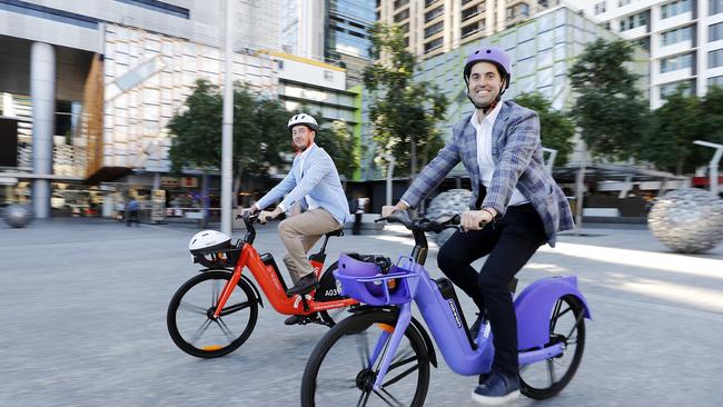 Jayden Bryant from Neuron mobility and Tom Cooper, Beam mobility in Brisbane on new electric bikes. Picture: Josh Woning