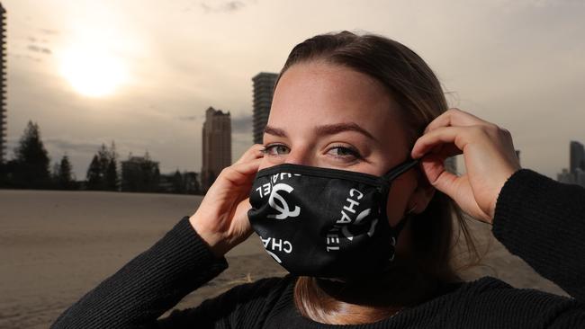 Local Crystal Fox wearing her very GC mask at Broadbeach on a cold winter’s afternoon. Picture: Glenn Hampson.