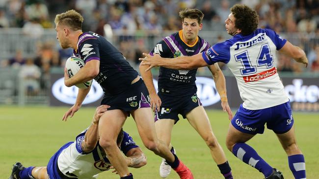 Cameron Munster looks for a teammate after making a break for the Storm/