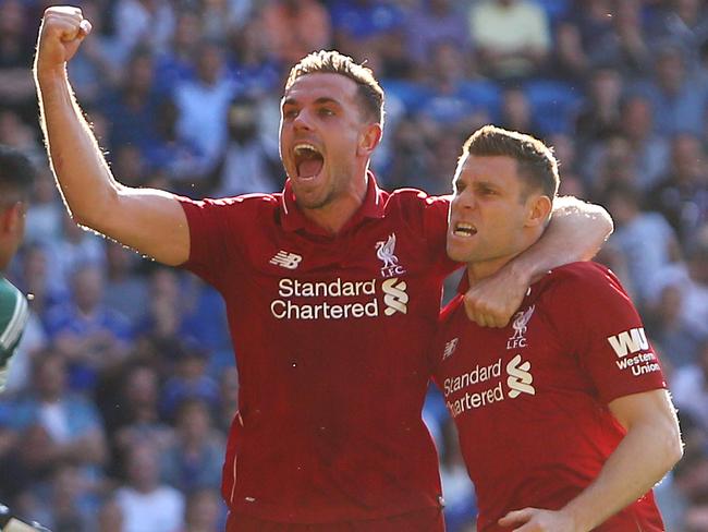 Liverpool's English midfielder James Milner (right) celebrates scoring from the penalty spot.