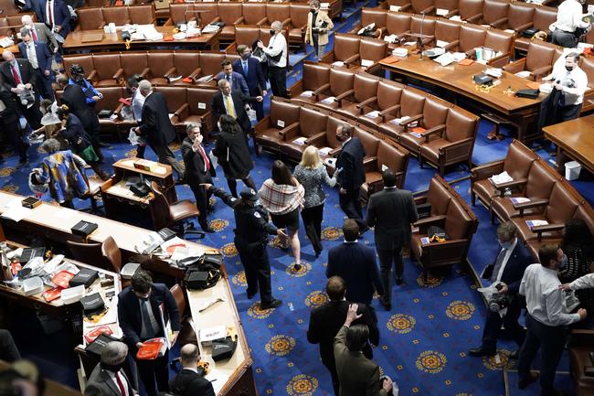 WASHINGTON, DC: Members of Congress evacuate the House Chamber as protesters enter during a joint session of Congress. Picture: Drew Angerer/Getty Images/AFP