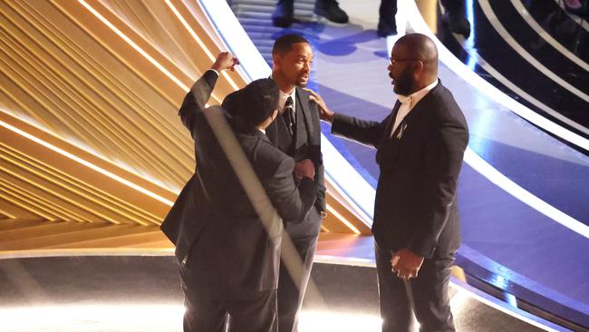 Denzel Washington and Tyler Perry comfort Smith after his outburst.