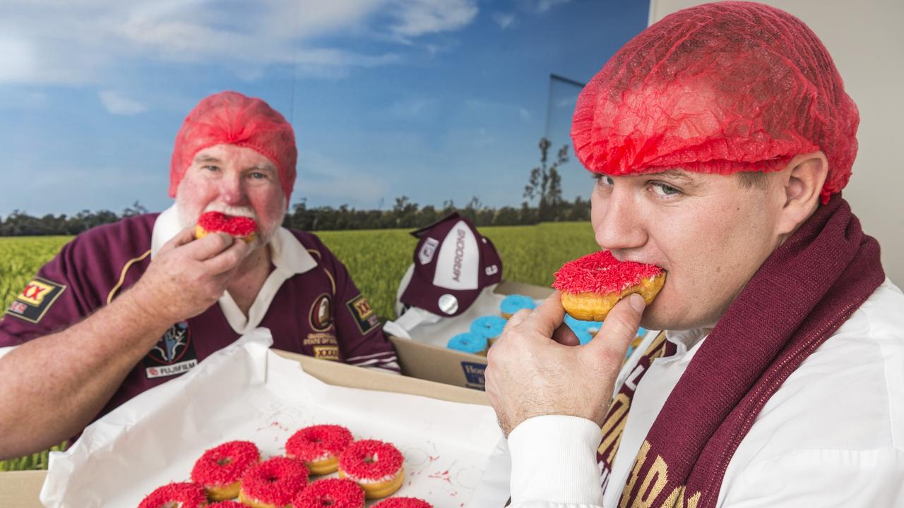 GAME DAY: Wearing their team’s colours with pride are Homestyle Bake Toowoomba director Lindsay Weber (left) and production supervisor Chris Rogers with the special State of Origin doughnuts. Picture: Kevin Farmer