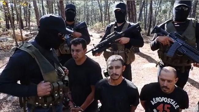 Members of the Jalisco New Generation cartel (CJNG) in Mexico record themselves with prisoners from a rival cartel. CJNG have been likened to terror group ISIS for their beheadings of rivals. Picture from YouTube