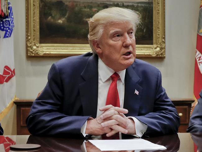 President Donald Trump, flanked by Independence Blue Cross CEO Daniel J. Hilferty, left, and Blue Cross and Blue Shield of North Carolina CEO Brad Wilson, speaks during a meeting with health insurance company executives in the Roosevelt Room of the White House in Washington, Monday, Feb. 27, 2017. (AP Photo/Pablo Martinez Monsivais)