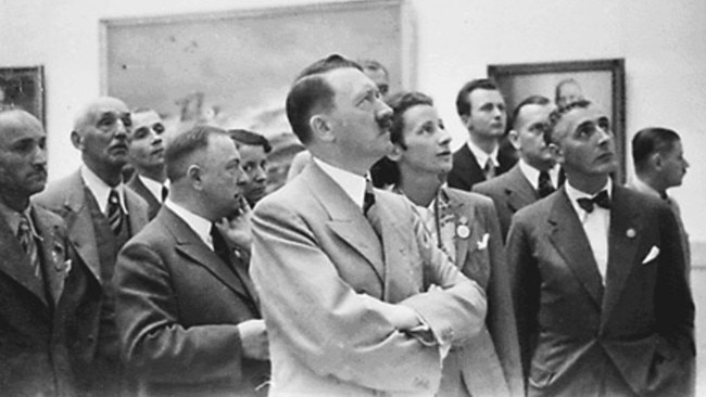 Adolf Hitler looks at stolen artwork at an art gallery in Munich during World War II.