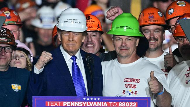 Members of "Steelworkers for Trump" pose with Republican presidential candidate Donald Trump during a campaign rally in Latrobe, Pennsylvania, at the weekend. Picture: Jim Watson / AFP)