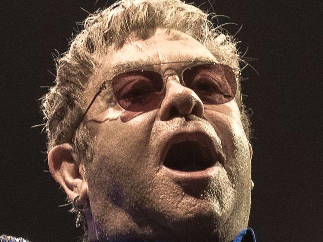 British singer Elton John gestures during a performance in Hong Kong on November 24, 2015. AFP PHOTO / Philippe Lopez