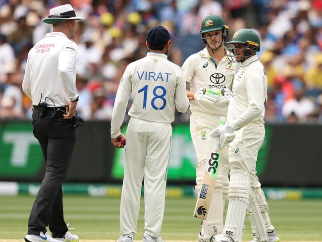 Umpire Michael Gough speaks with Virat Kohli and Sam Konstas after the incident. Picture: Getty