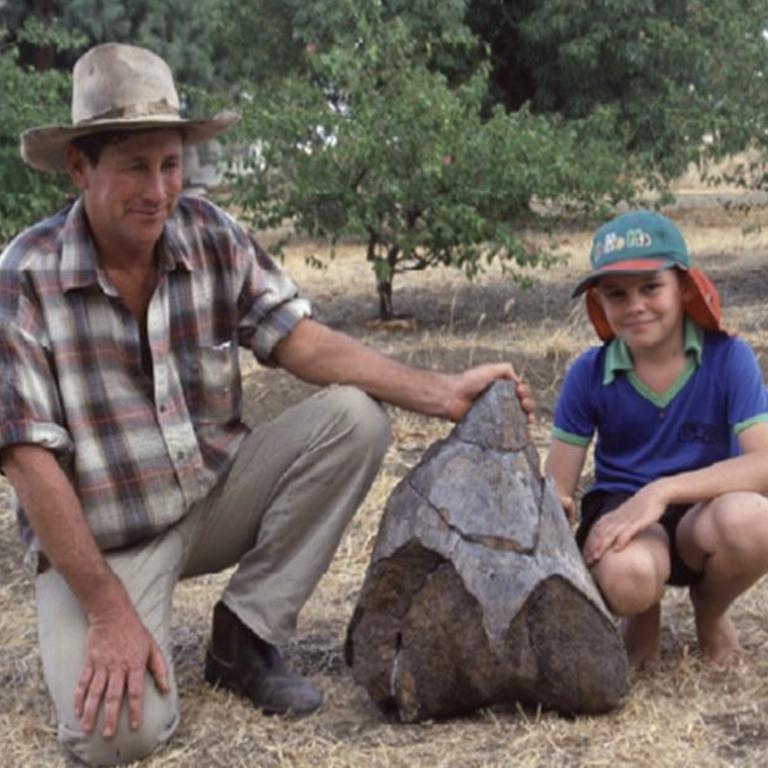 Dave Elliott and his son Harry proudly display the lower part of the thighbone of the sauropod. Picture: Australia Age of Dinosaurs museum.