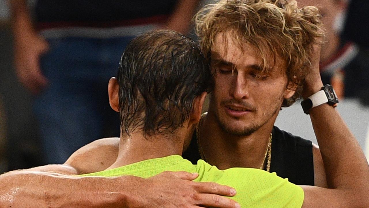 Alexander Zverev embraces Rafael Nadal after being injured during his men's semi-final singles match. (Photo by Christophe ARCHAMBAULT / AFP)
